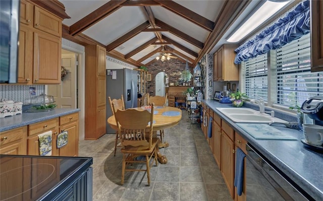 kitchen with stainless steel refrigerator with ice dispenser, a sink, ceiling fan, dishwasher, and vaulted ceiling with beams
