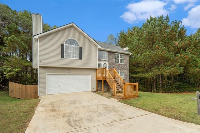 bi-level home with a garage and a front yard