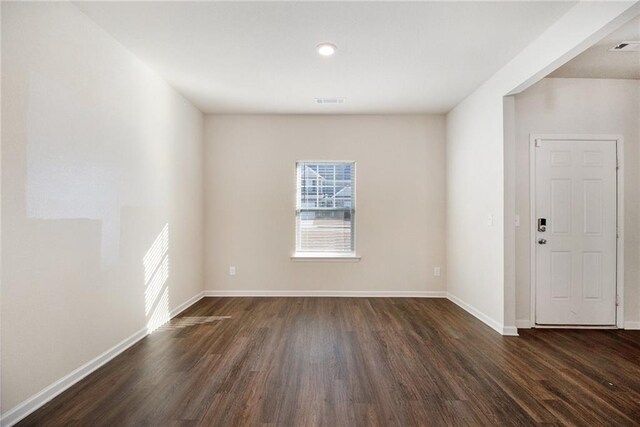 unfurnished dining area featuring ceiling fan with notable chandelier and dark wood-type flooring