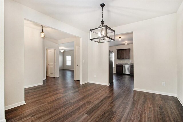 kitchen featuring stainless steel appliances, sink, dark brown cabinets, and dark wood-type flooring