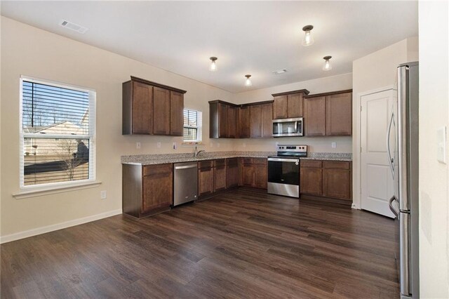 bathroom with toilet and hardwood / wood-style floors