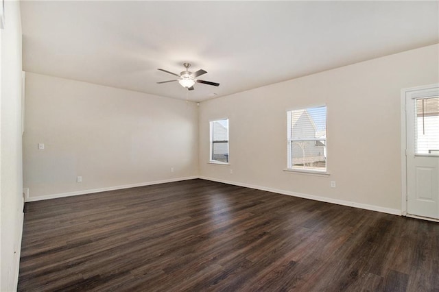 unfurnished room featuring ceiling fan, a wealth of natural light, and dark hardwood / wood-style floors