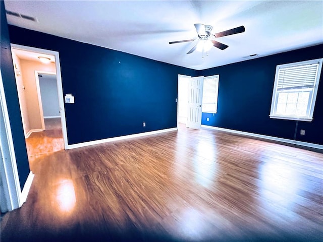 3460 Ebenezer Rd, Marietta, GA 30066 - unfurnished room featuring a ceiling fan, wood finished floors, and healthy amount of natural light