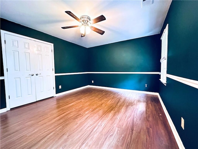 3460 Ebenezer Rd, Marietta, GA 30066 - unfurnished bedroom featuring wood finished floors, a ceiling fan, and a closet