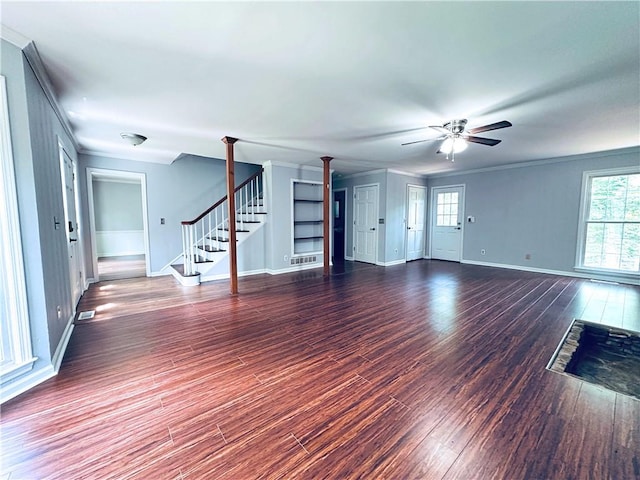 3460 Ebenezer Rd, Marietta, GA 30066 - unfurnished living room with crown molding, stairs, healthy amount of natural light, a ceiling fan, and wood finished floors