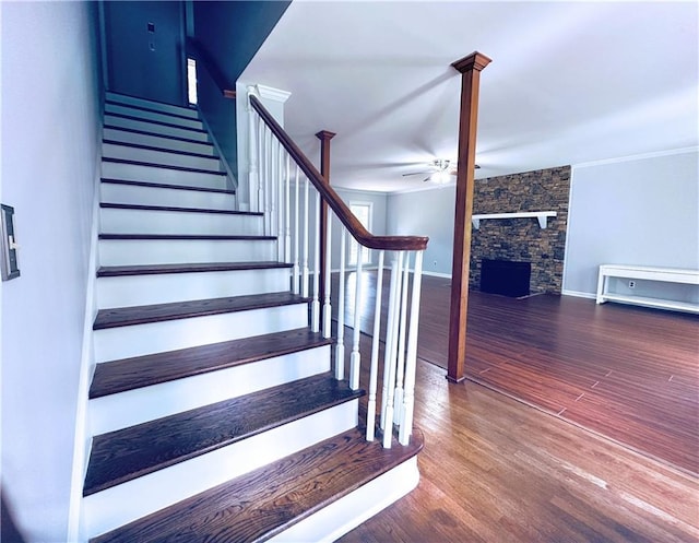 3460 Ebenezer Rd, Marietta, GA 30066 - staircase with ceiling fan, wood finished floors, a fireplace, and crown molding
