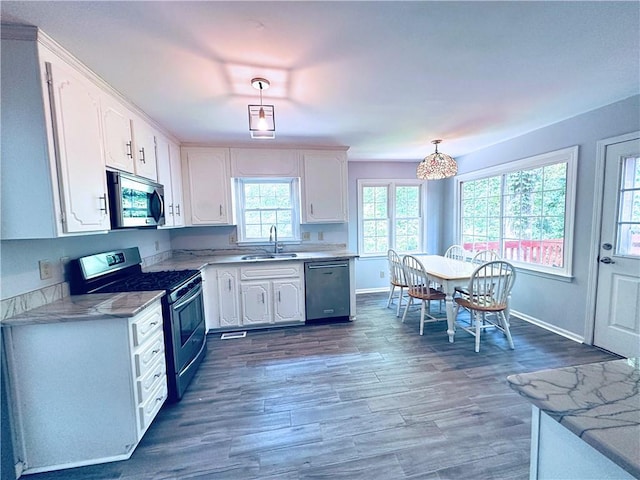 3460 Ebenezer Rd, Marietta, GA 30066 - kitchen featuring appliances with stainless steel finishes, white cabinets, pendant lighting, and light countertops