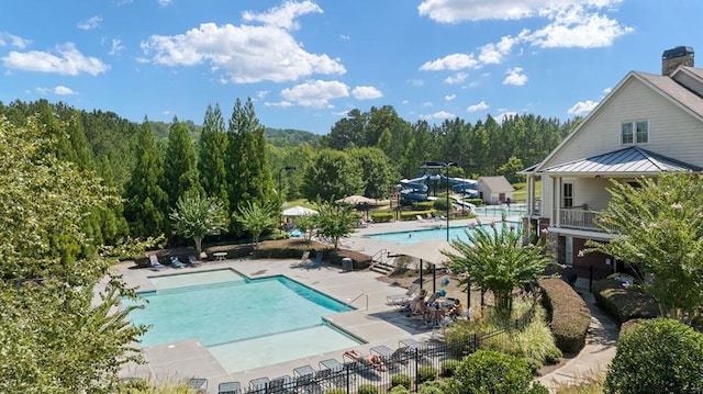 366 Lost Creek Blvd, Dallas, GA 30132 - community pool with a water slide, a patio area, and a view of trees