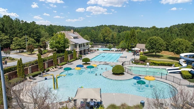 366 Lost Creek Blvd, Dallas, GA 30132 - community pool with a water play area, a water slide, a forest view, and a patio