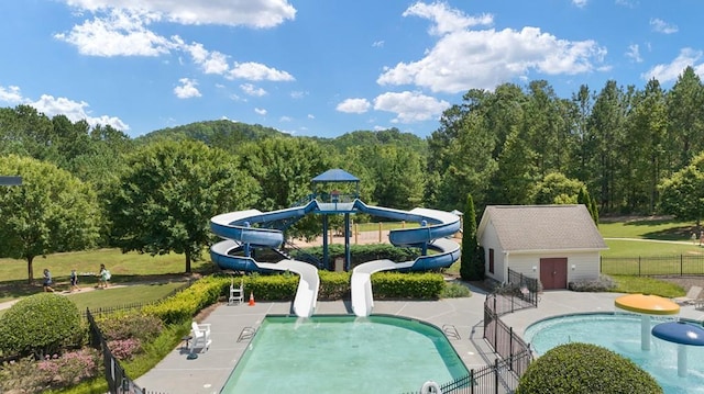366 Lost Creek Blvd, Dallas, GA 30132 - community pool with a water slide, a forest view, and a patio area