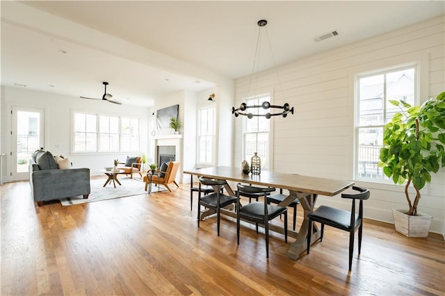 dining area featuring wood-type flooring and a fireplace