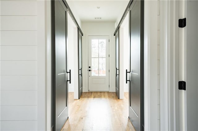 doorway to outside with light hardwood / wood-style flooring