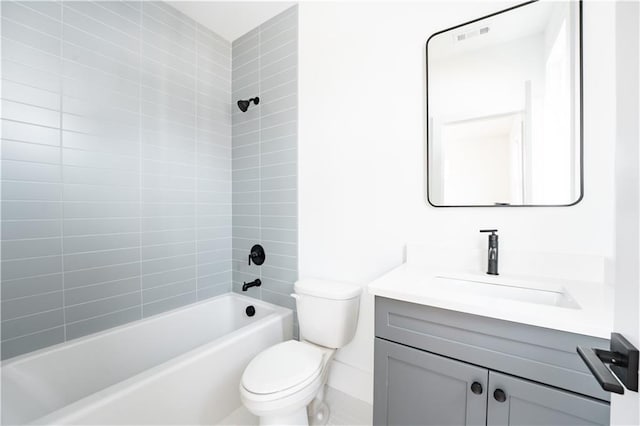 full bathroom with tiled shower / bath combo, vanity, and toilet