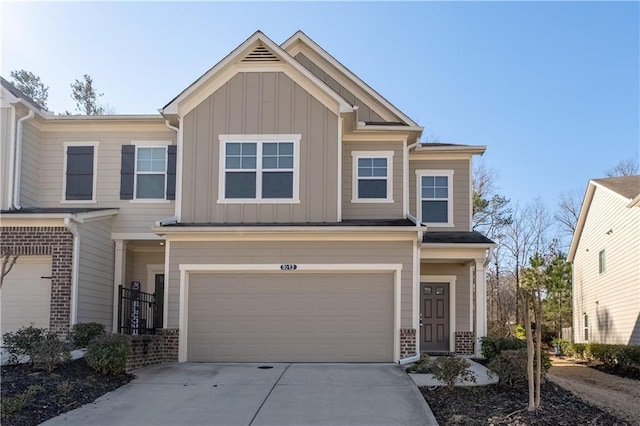 view of front of home featuring an attached garage, brick siding, board and batten siding, and concrete driveway