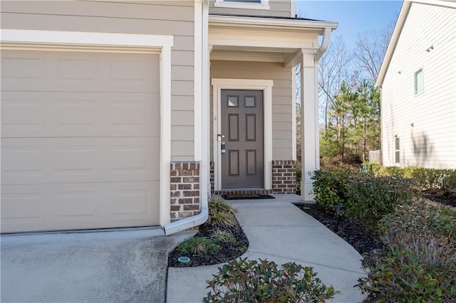 doorway to property with brick siding