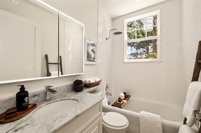 bathroom featuring tub / shower combination, toilet, and vanity