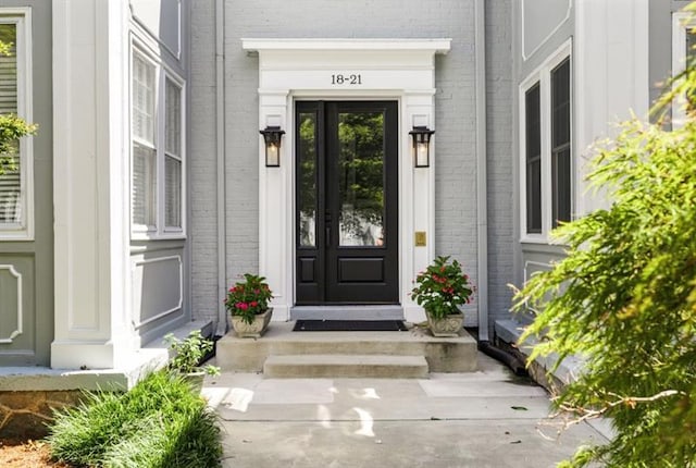 view of exterior entry with brick siding