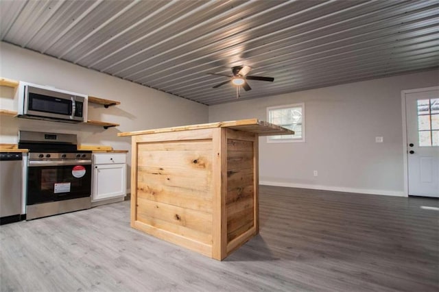 2125 Mccollum Church Rd, Lineville, AL 36266 - kitchen featuring appliances with stainless steel finishes, open shelves, light wood finished floors, ceiling fan, and white cabinets
