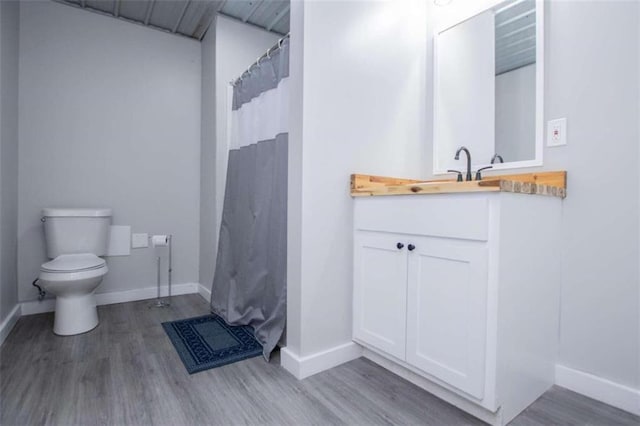 2125 Mccollum Church Rd, Lineville, AL 36266 - full bathroom with toilet, wood finished floors, vanity, and baseboards