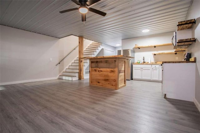 2125 Mccollum Church Rd, Lineville, AL 36266 - unfurnished living room with a ceiling fan, baseboards, wood finished floors, stairway, and a sink