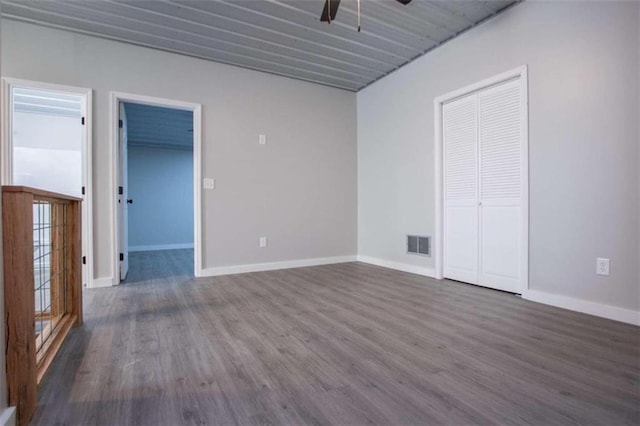 2125 Mccollum Church Rd, Lineville, AL 36266 - unfurnished room featuring a ceiling fan, dark wood-type flooring, and baseboards