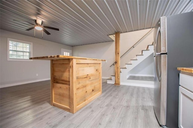 2125 Mccollum Church Rd, Lineville, AL 36266 - bar with freestanding refrigerator, light wood finished floors, stairs, and baseboards
