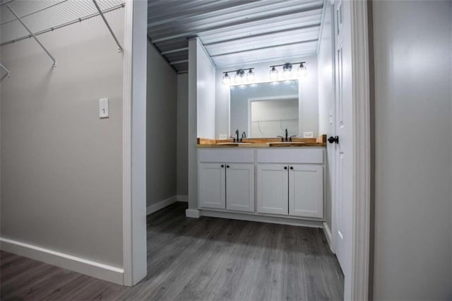 2125 Mccollum Church Rd, Lineville, AL 36266 - bathroom with wood finished floors, double vanity, and baseboards