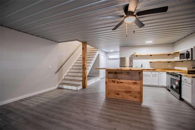 2125 Mccollum Church Rd, Lineville, AL 36266 - kitchen with appliances with stainless steel finishes, open shelves, white cabinets, and dark wood-style flooring