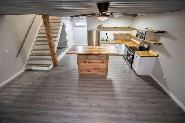 2125 Mccollum Church Rd, Lineville, AL 36266 - kitchen featuring stainless steel appliances, butcher block countertops, a ceiling fan, white cabinetry, and baseboards