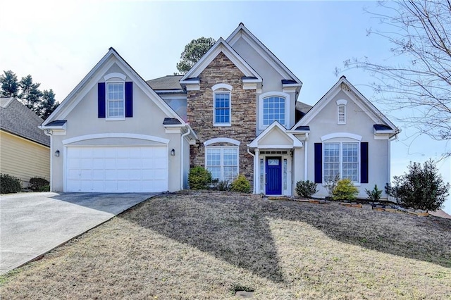 traditional-style house featuring stone siding, an attached garage, concrete driveway, and stucco siding