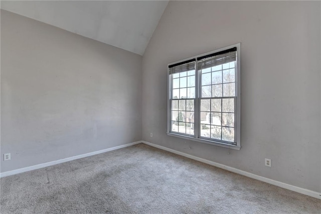 unfurnished room with high vaulted ceiling, carpet flooring, and baseboards