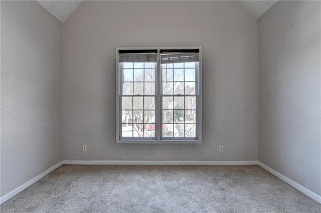 unfurnished room with lofted ceiling, carpet flooring, and baseboards