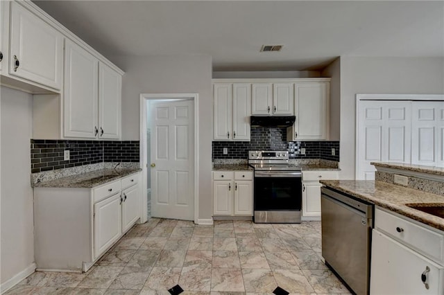 kitchen featuring under cabinet range hood, white cabinetry, visible vents, appliances with stainless steel finishes, and light stone countertops