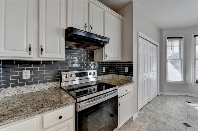 kitchen featuring light stone counters, marble finish floor, stainless steel range with electric cooktop, white cabinets, and under cabinet range hood