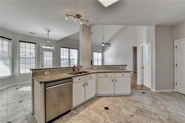 kitchen with a sink, visible vents, baseboards, white cabinetry, and stainless steel dishwasher