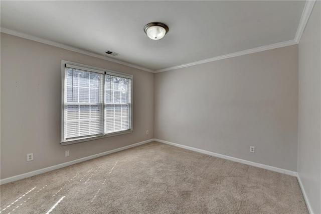 carpeted spare room featuring baseboards, visible vents, and ornamental molding