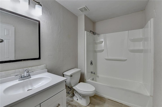 bathroom with visible vents, a textured wall, toilet, wood finished floors, and vanity