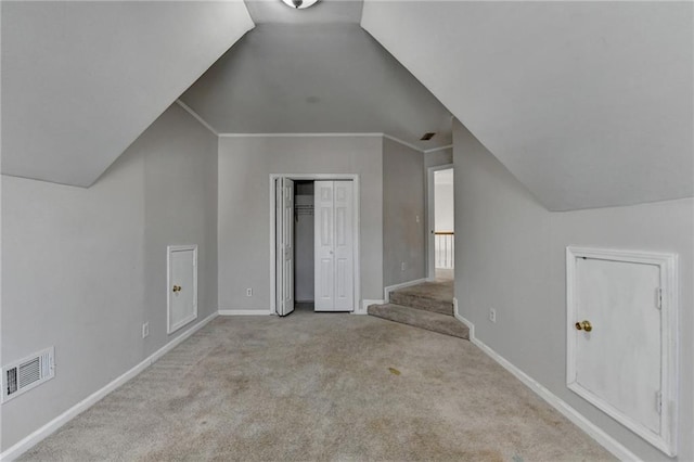 bonus room with lofted ceiling, carpet flooring, visible vents, baseboards, and stairs