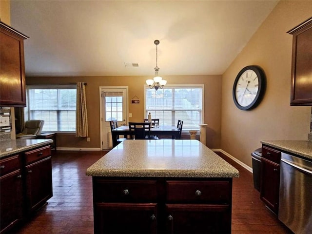 kitchen with dark hardwood / wood-style flooring, lofted ceiling, stainless steel dishwasher, and a kitchen island