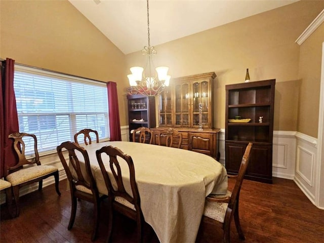 dining room featuring dark wood-type flooring, lofted ceiling, and a notable chandelier