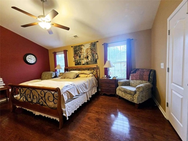 bedroom featuring multiple windows, lofted ceiling, ceiling fan, and dark hardwood / wood-style floors