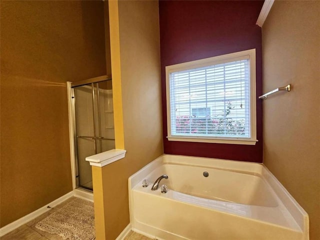 bathroom featuring tile patterned flooring and shower with separate bathtub