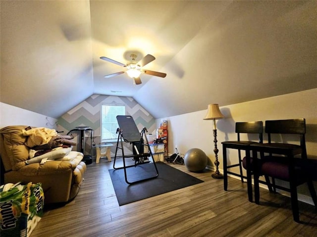 exercise room featuring ceiling fan, dark hardwood / wood-style floors, and lofted ceiling