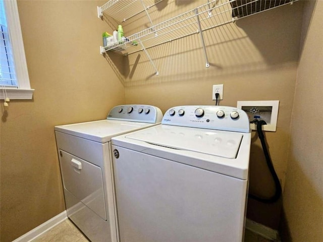 laundry area featuring light tile patterned flooring and independent washer and dryer