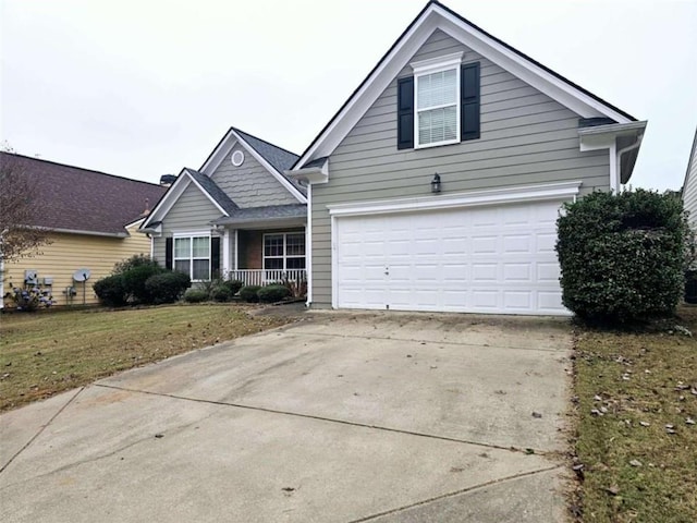 view of front of house with a garage and a front lawn