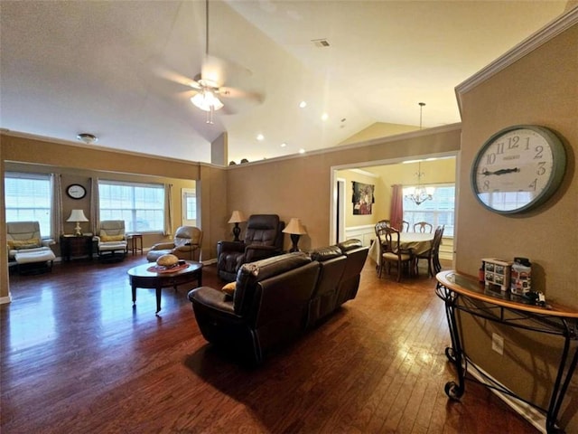 living room featuring dark hardwood / wood-style flooring, ceiling fan with notable chandelier, and lofted ceiling