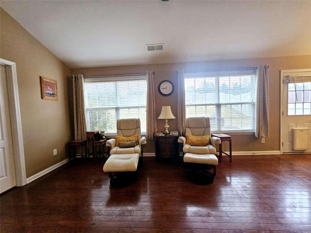 sitting room featuring dark wood-type flooring, plenty of natural light, and vaulted ceiling