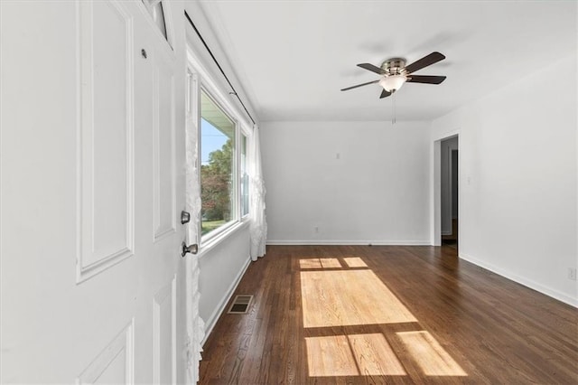 spare room with dark hardwood / wood-style floors and ceiling fan