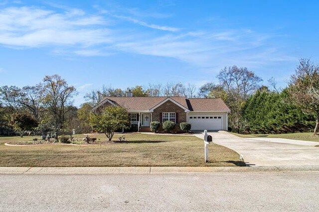 single story home featuring a garage and a front lawn