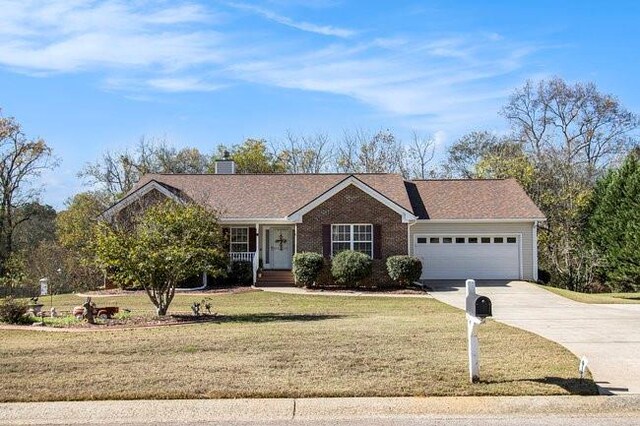 ranch-style house featuring a front yard and a garage